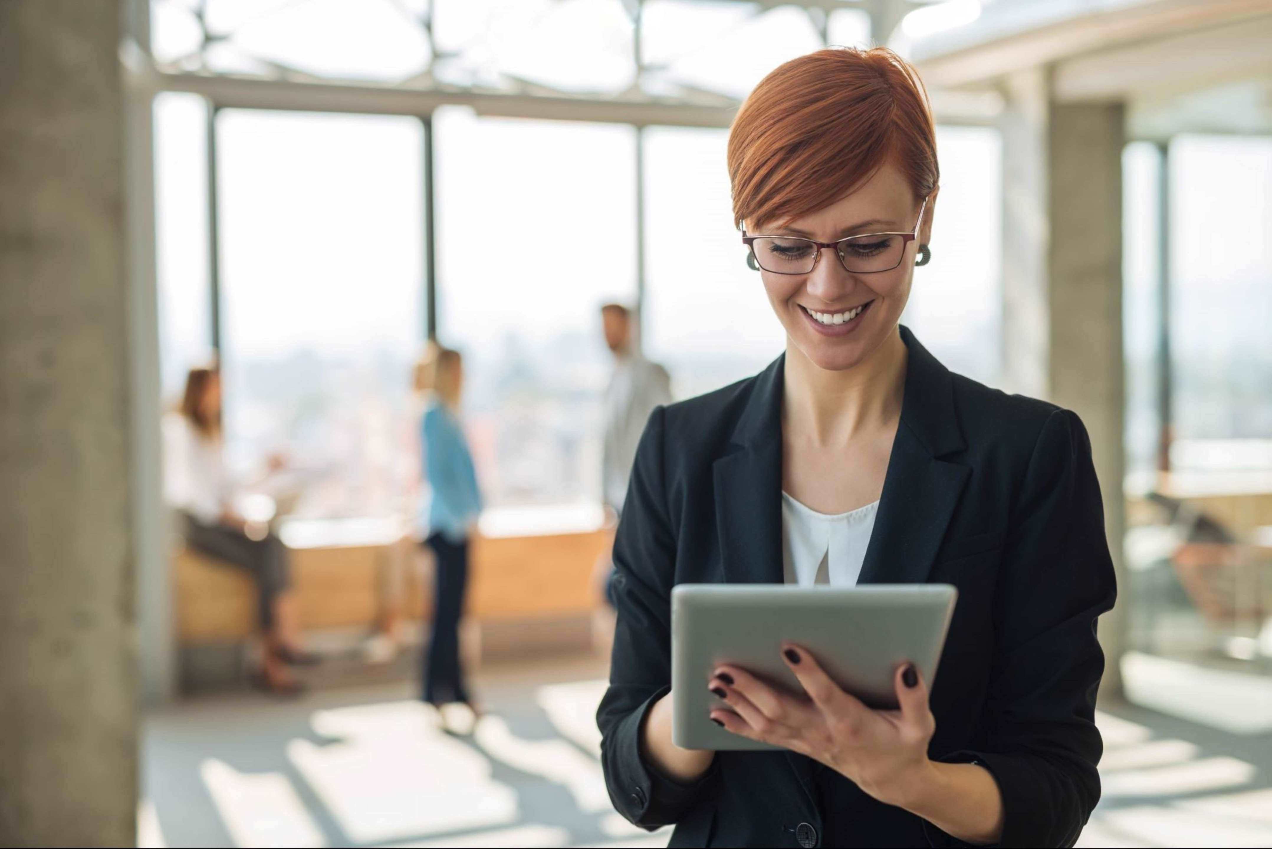 Woman in office looking at a tablet