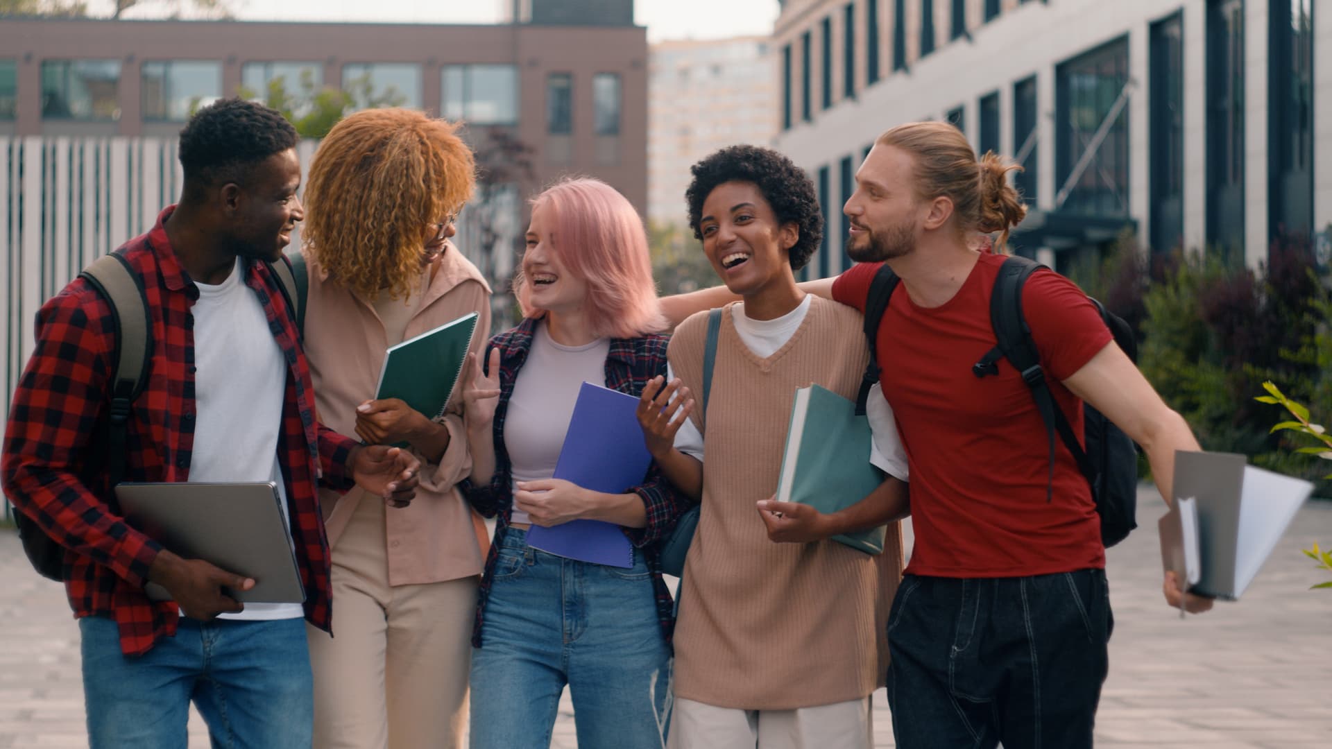 A group of diverse students standing together and smiling.
