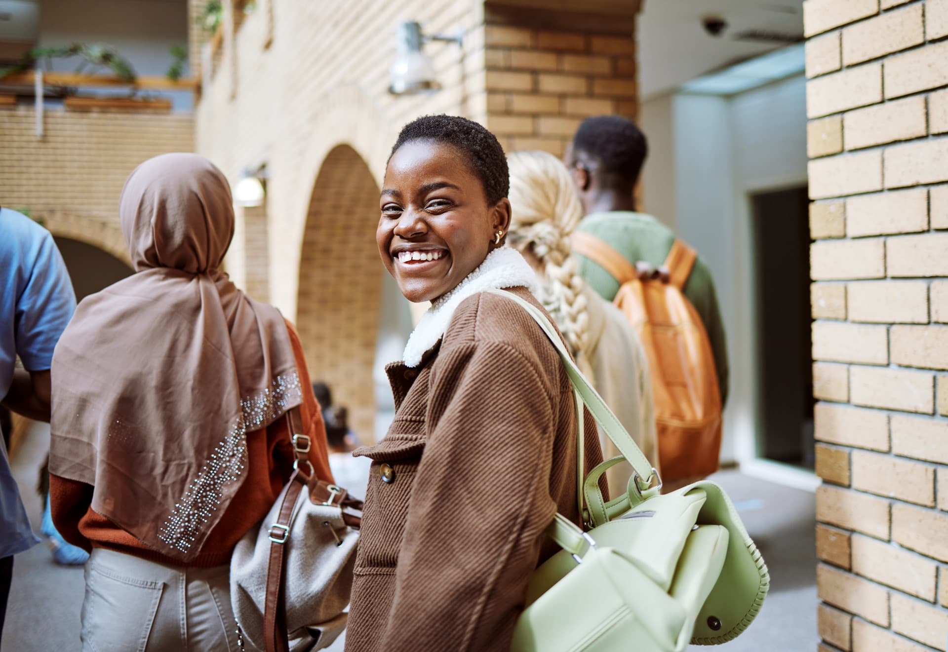 Woman walking with friends to class.